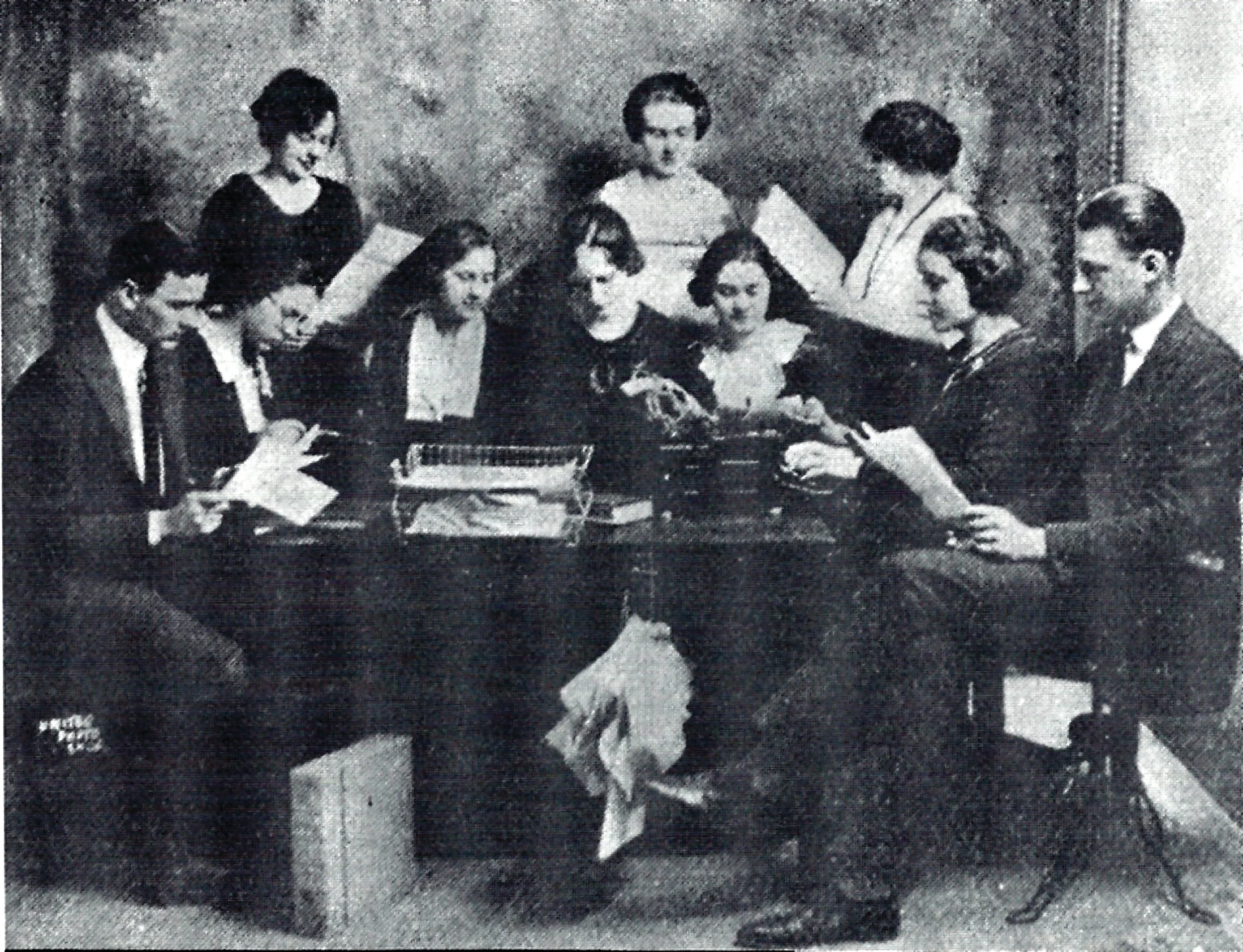 Group of people reading a journal